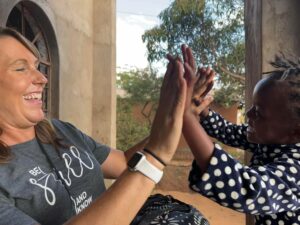 woman and little girl high fiving